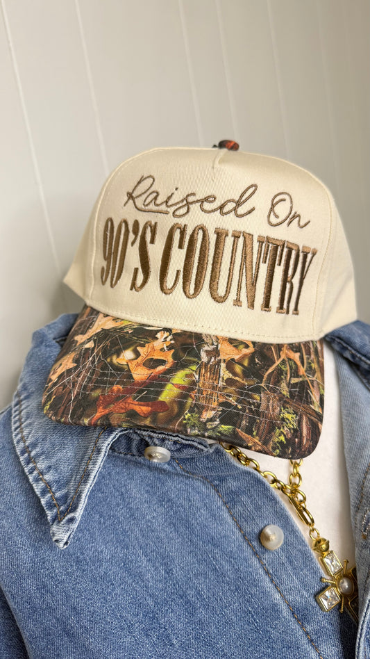 Raised On 90’s Country Camo Trucker Hat
