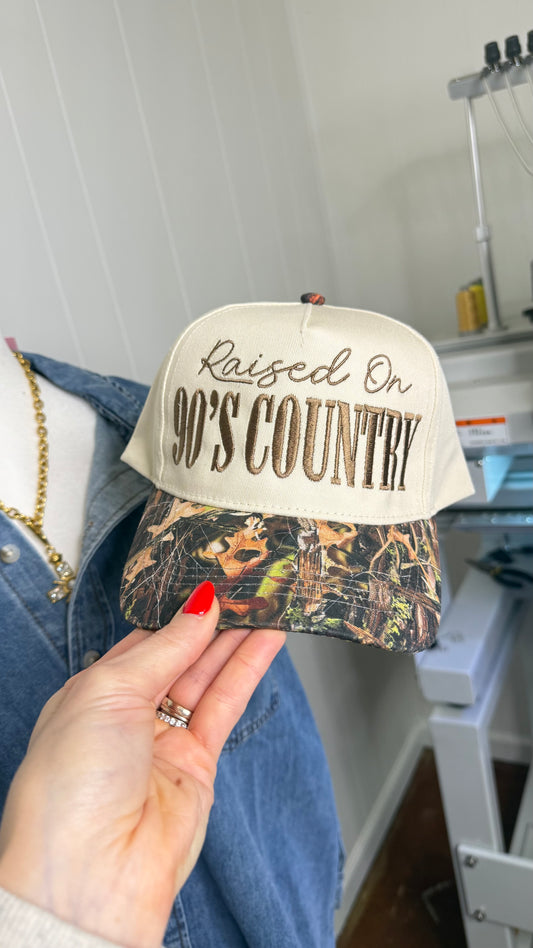 Raised On 90’s Country Camo Trucker Hat